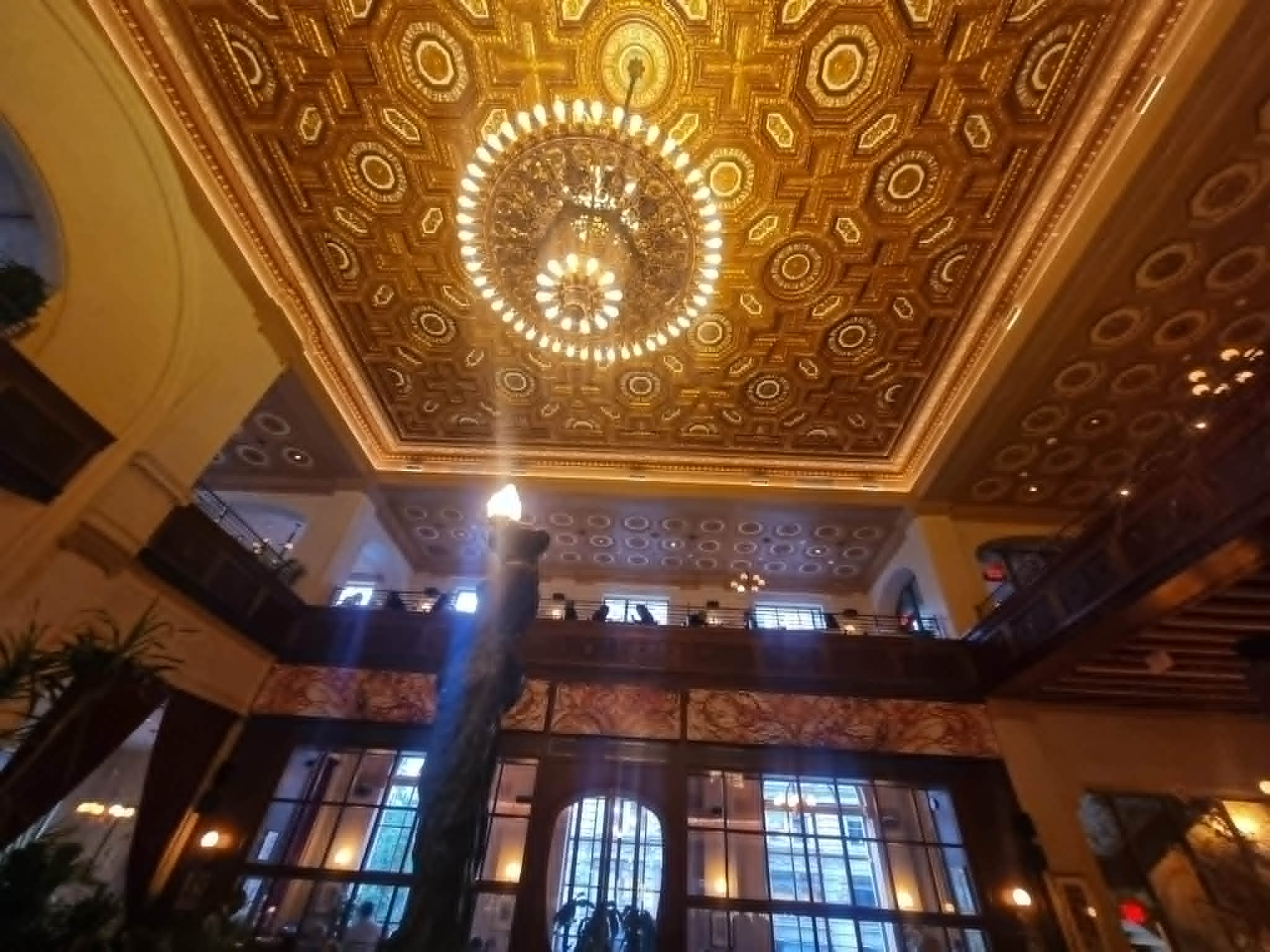 The ornate gilded ceiling and chandelier of La Grande Boucherie, Washington DC